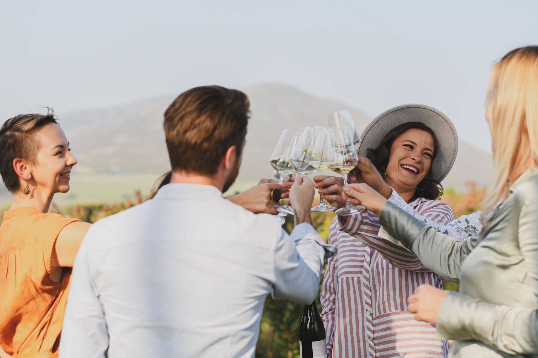 Guests raising glasses at an outdoor event, photographed for social content