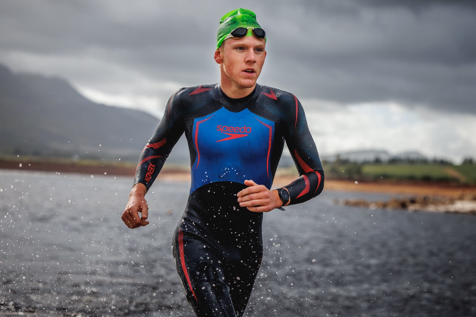 Athlete running through a storm during an XTERRA event